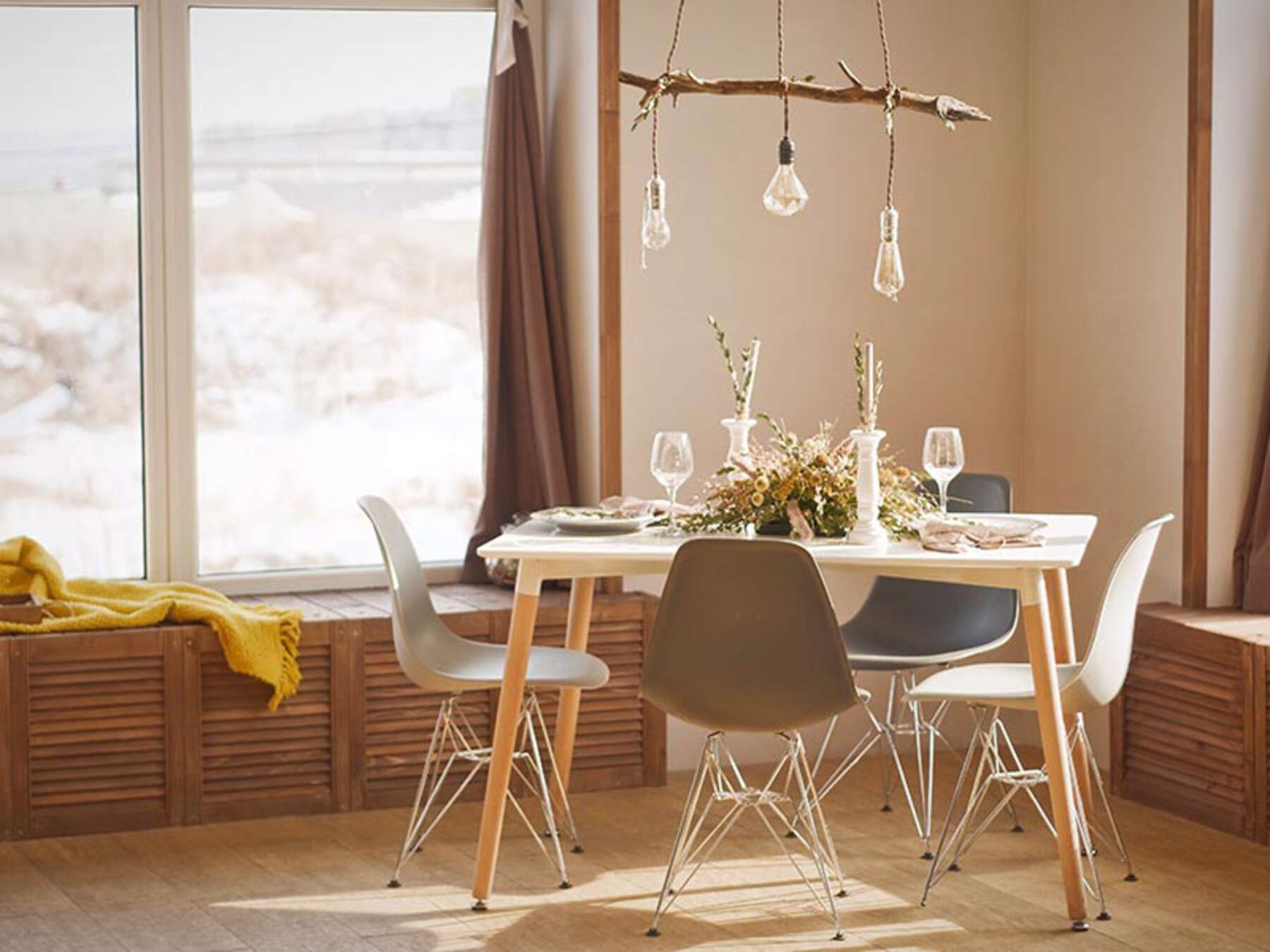 A green table with two pictures on the wall